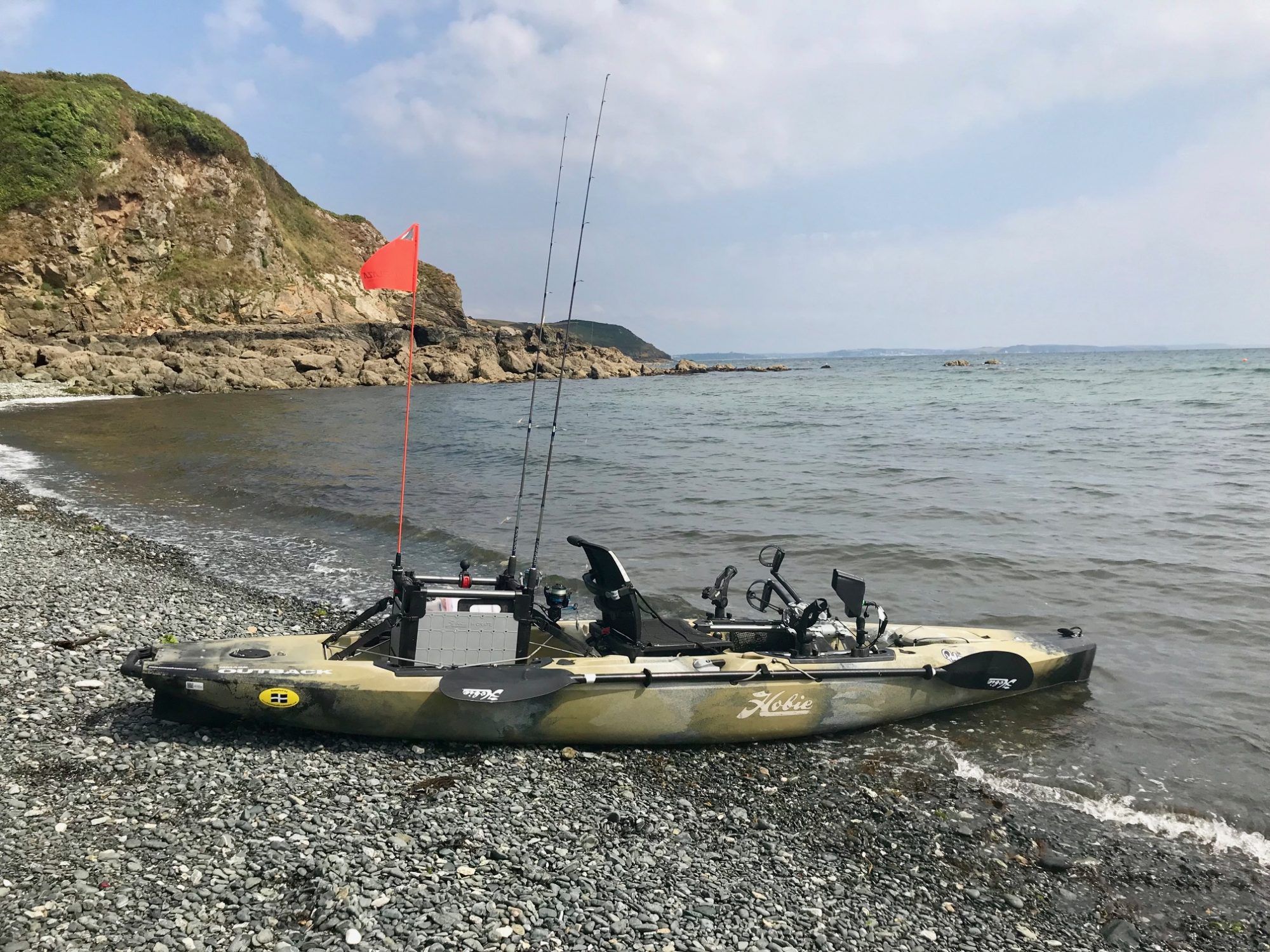 Launching a fishing kayak from a beach